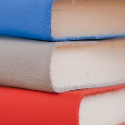 A stack of books in blue, white and red.