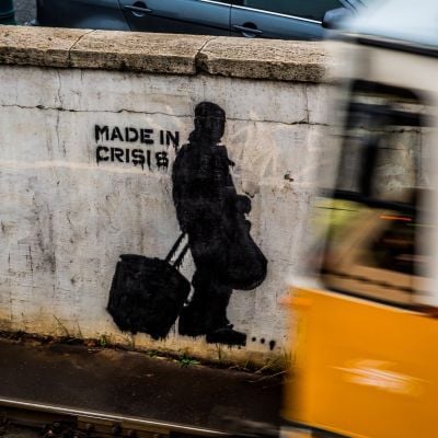 Stencil street art on a wall at a metro line. Photo by Robert Metz from Unsplash
