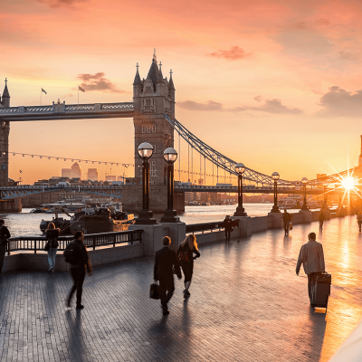 The Tower Bridge in London during sunrise and people rushing to their work