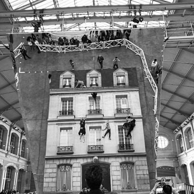 Photo of an installation by Leandro Erlich of a mirrored building in black and white