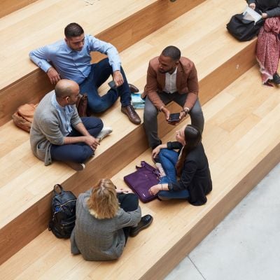 Postgraduate students taking a break on the steps