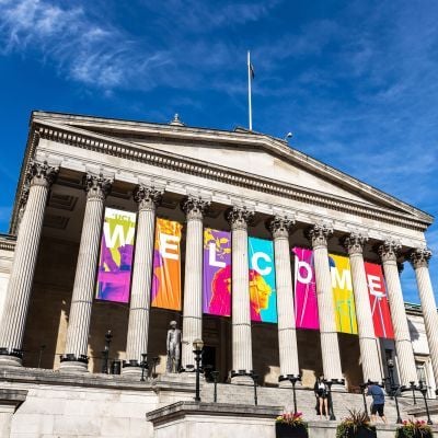 External photo of UCL main building with a welcome banner
