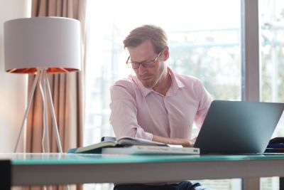Male Postgraduate Student working at home