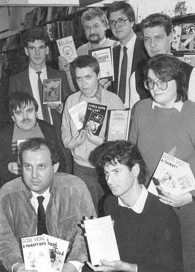 Black and white photo of defendants with seized books in 1984