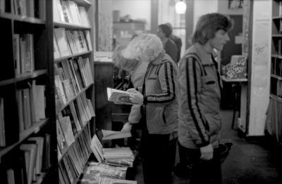 A black and white photo of customers inside Gay's The Word bookshop