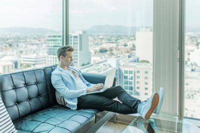 Man on a laptop on a sofa