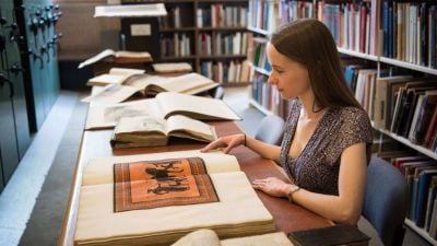 Female person viewing a book in the Combined Classics Library