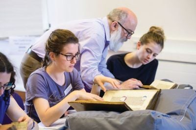 Female student studying a history book item from Senate House Library