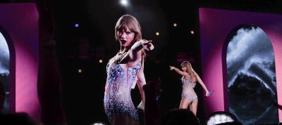 Taylor Swift performing on stage during the Eras Tour.