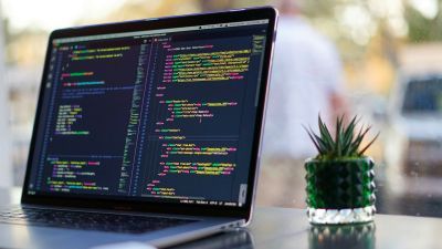 A laptop with coloured Python code on the screen
