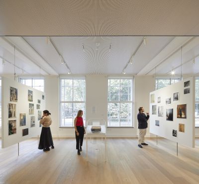 Visitors to the Kythera Gallery at the Warburg Institute, examining an exhibition.