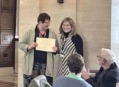 Professor Vosgerau receiving her award from The Director of CODE, Dr Linda Amrane-Cooper