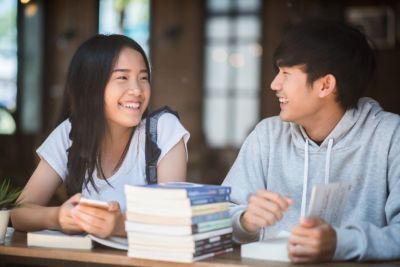 2 people looking at each other smiling