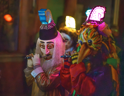 People in costumes playing flutes