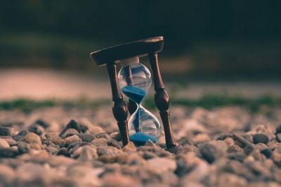 Sand timer on some pebbles