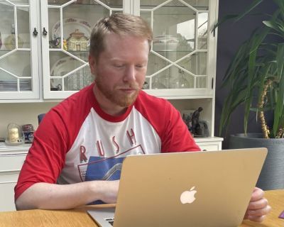 Brian studying behind a laptop on a desk