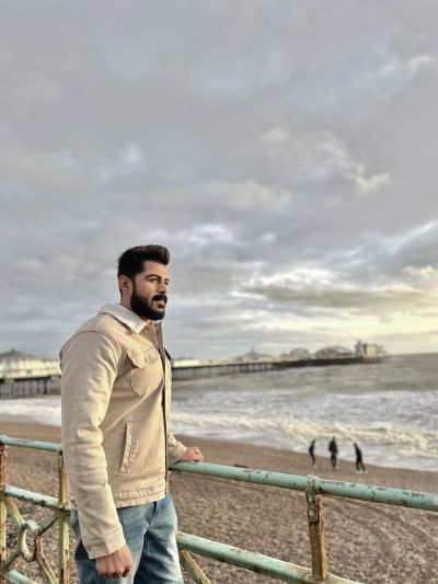 Omer standing by the seaside relaxing