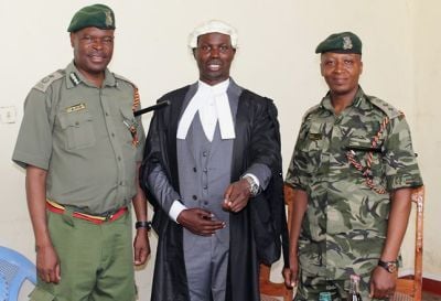 William Okumu with prison staff