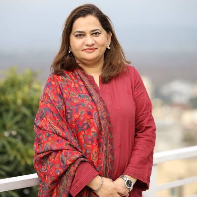 Safia Cassim standing by a view wearing red.