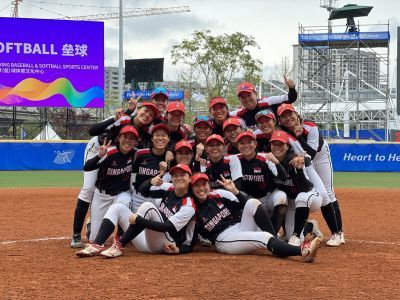 A team photo of the Singapore women's softball team in uniform.