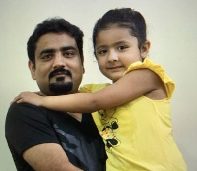 A father holding his daughter.