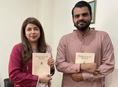 Tasneem and Mustafa, Chief Editor and Editor of the Pakistan Law Review, hold copies of the publication.