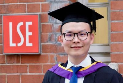 HKU student next to LSE sign