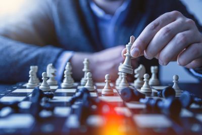 Person placing chess pieces on a chess board
