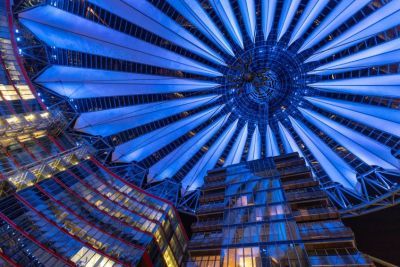 A futuristic scene with high rise buildings and a spiral roof design.