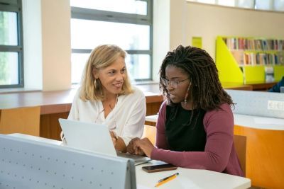 A female student and a female teacher, studying together