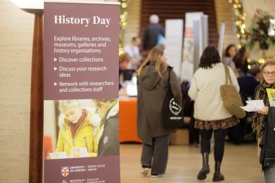 People in Crush Hall with a History Day roller banner in the foreground