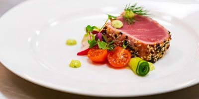 Fine dinning: salmon dish with cherry tomatoes and cucumber
